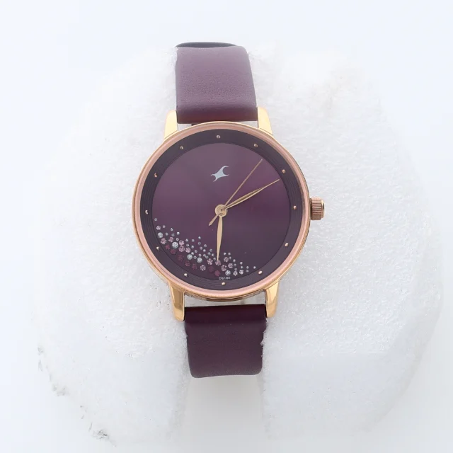 A wristwatch with a plum dial and strap