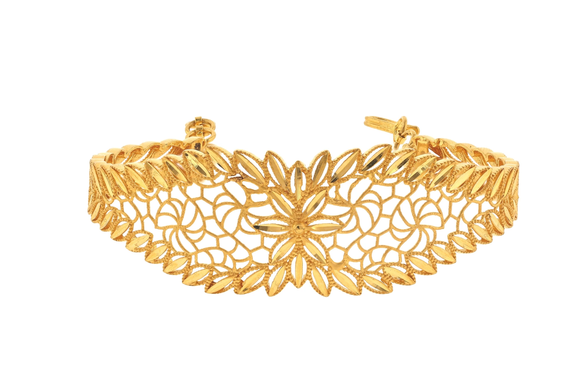Gold filigree jewellery photographed on a white background