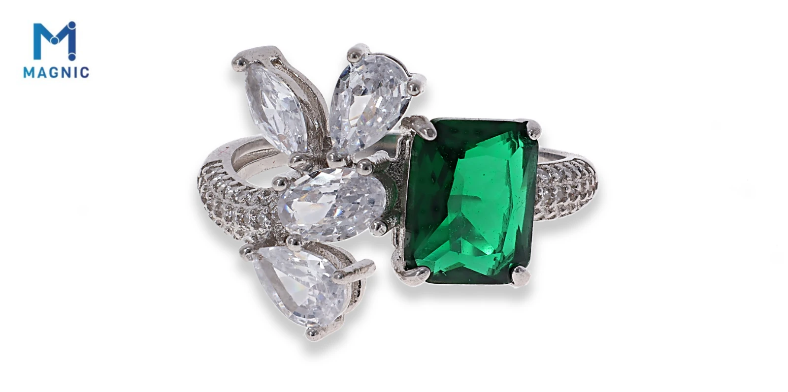 The finished ring photo: a silver ring with clear and green stones on white, with a soft shadow and the Magnic logo